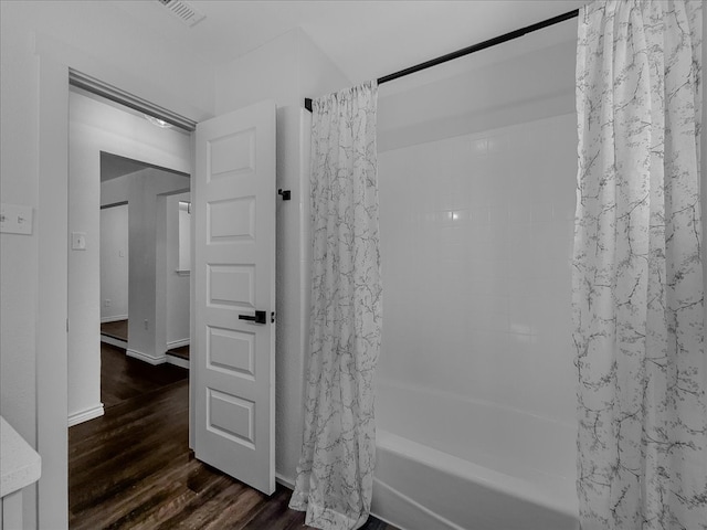 777 NW Charlyne Dr, Burleson, TX 76028 - full bath featuring wood finished floors and shower / bathtub combination with curtain