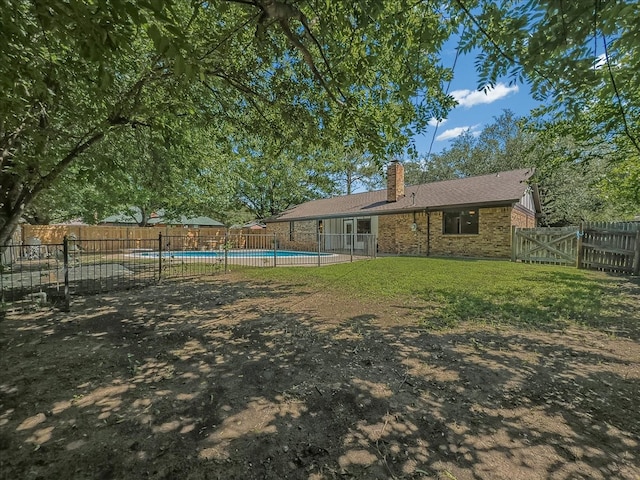 777 NW Charlyne Dr, Burleson, TX 76028 - back of house with brick siding and a chimney