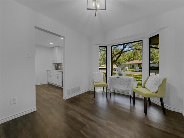 777 NW Charlyne Dr, Burleson, TX 76028 - sitting room with healthy amount of natural light, dark wood finished floors, and baseboards