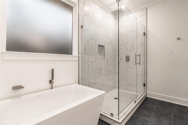 216 Pauline St, Arp, TX 75750 - full bathroom featuring a marble finish shower, tile patterned floors, a freestanding tub, and baseboards