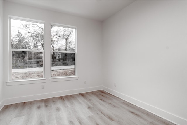 216 Pauline St, Arp, TX 75750 - empty room featuring plenty of natural light, light wood-type flooring, and baseboards