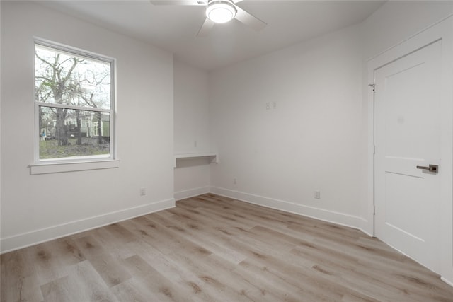 216 Pauline St, Arp, TX 75750 - empty room featuring a ceiling fan, light wood finished floors, and baseboards