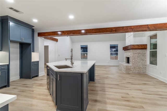 216 Pauline St, Arp, TX 75750 - kitchen with a sink, light countertops, light wood-style floors, baseboards, and beamed ceiling