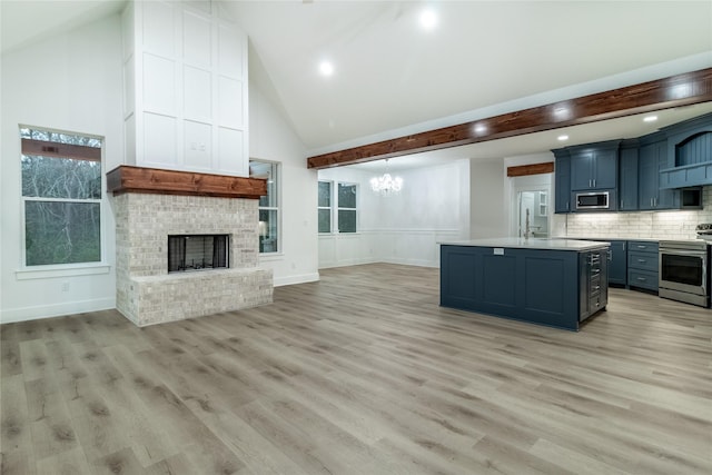 216 Pauline St, Arp, TX 75750 - kitchen with stainless steel appliances, light countertops, a chandelier, open floor plan, and a kitchen island