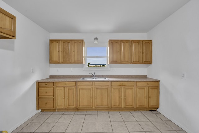 329 Worthy St, Saginaw, TX 76179 - kitchen with a sink, baseboards, light tile patterned floors, and brown cabinetry