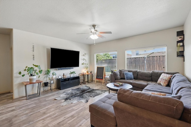 7113 Creighton Ct, Fort Worth, TX 76120 - living area featuring ceiling fan, light wood-type flooring, and a textured ceiling
