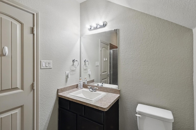 7113 Creighton Ct, Fort Worth, TX 76120 - bathroom featuring toilet, a textured wall, and vanity