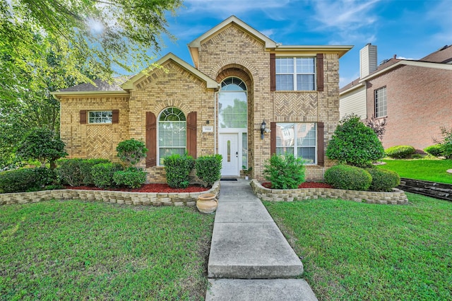 1102 Mccormick St, Garland, TX 75040 - traditional-style house featuring brick siding and a front yard