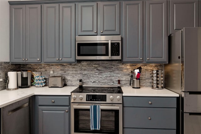 5798 Antique Rose Trl, Fairview, TX 75069 - kitchen featuring gray cabinets, stainless steel appliances, tasteful backsplash, and light countertops