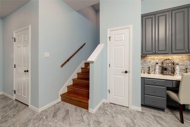 5798 Antique Rose Trl, Fairview, TX 75069 - stairs featuring baseboards, built in study area, and marble finish flooring