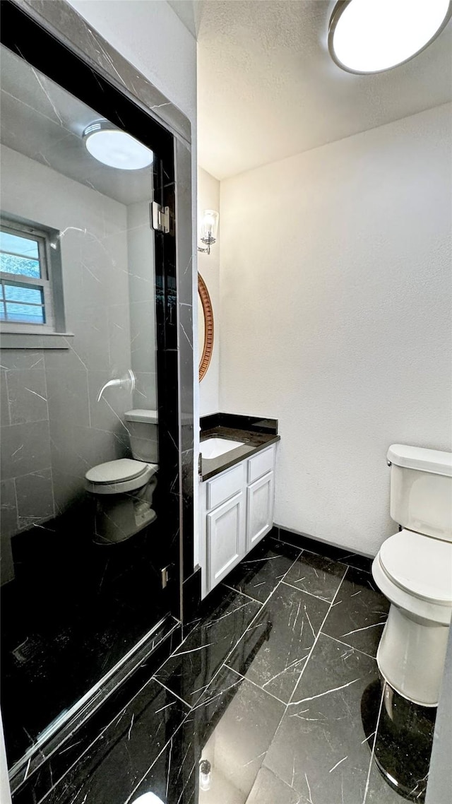 3315 Cedarcroft Ln, Dallas, TX 75233 - full bath with vanity, toilet, marble finish flooring, a tile shower, and baseboards