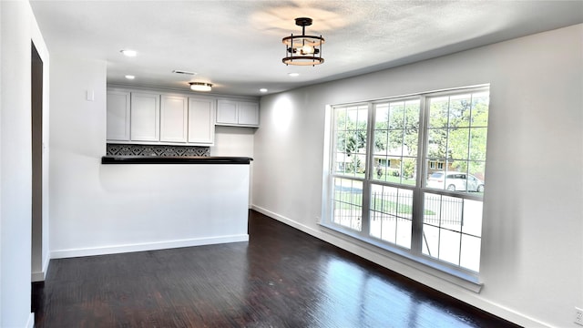 3315 Cedarcroft Ln, Dallas, TX 75233 - kitchen with dark wood-style floors, baseboards, recessed lighting, pendant lighting, and a chandelier