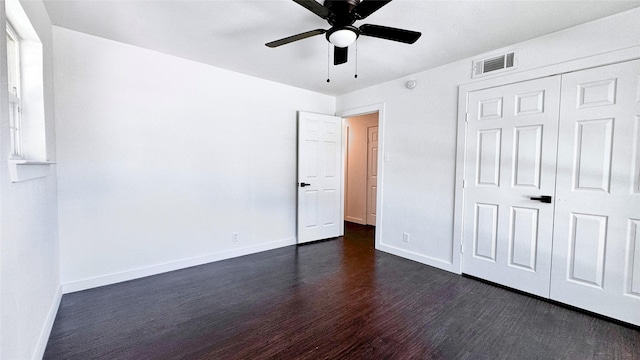 3315 Cedarcroft Ln, Dallas, TX 75233 - unfurnished bedroom featuring dark wood-style flooring, baseboards, ceiling fan, and a closet