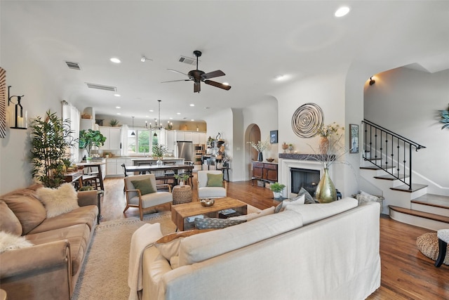 261 Casa Blanca Ave, Fort Worth, TX 76107 - living room with arched walkways, ceiling fan, wood finished floors, recessed lighting, and stairs