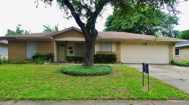 212 E Kearney St, Mesquite, TX 75149 - ranch-style house with concrete driveway, a garage, brick siding, and a front lawn