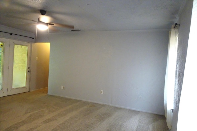 212 E Kearney St, Mesquite, TX 75149 - unfurnished room featuring light colored carpet, a ceiling fan, baseboards, and a textured ceiling