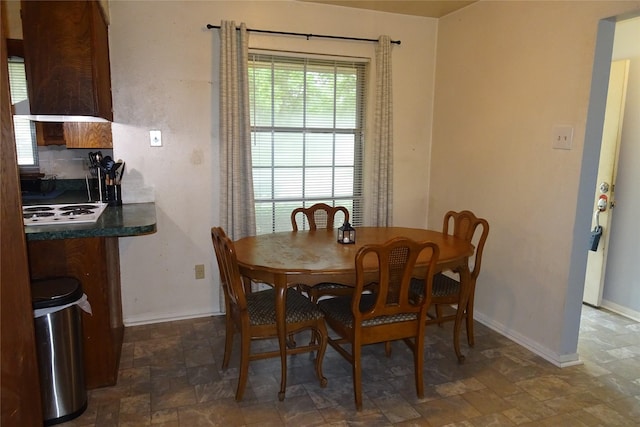 212 E Kearney St, Mesquite, TX 75149 - dining room featuring stone finish flooring and baseboards