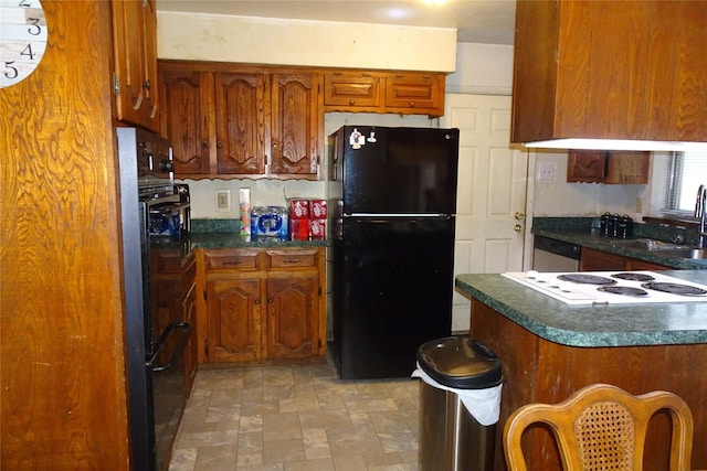 212 E Kearney St, Mesquite, TX 75149 - kitchen with freestanding refrigerator, dark countertops, white electric cooktop, a sink, and brown cabinets