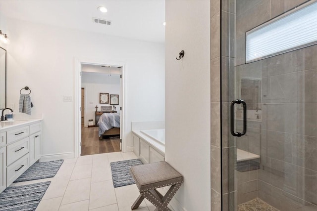 10116 T Bury Ln, Waco, TX 76708 - full bathroom featuring a shower stall, tile patterned floors, connected bathroom, vanity, and a garden tub