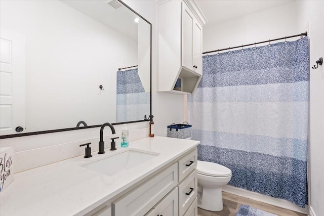 10116 T Bury Ln, Waco, TX 76708 - bathroom with vanity, toilet, wood finished floors, and curtained shower