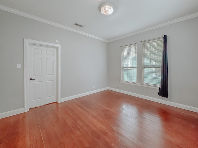 1530 W 5th Ave, Corsicana, TX 75110 - empty room with wood finished floors, crown molding, and baseboards