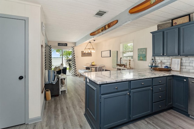 166 Ocean Dr, Gun Barrel City, TX 75156 - kitchen with a peninsula, light wood-style floors, blue cabinetry, and light stone countertops
