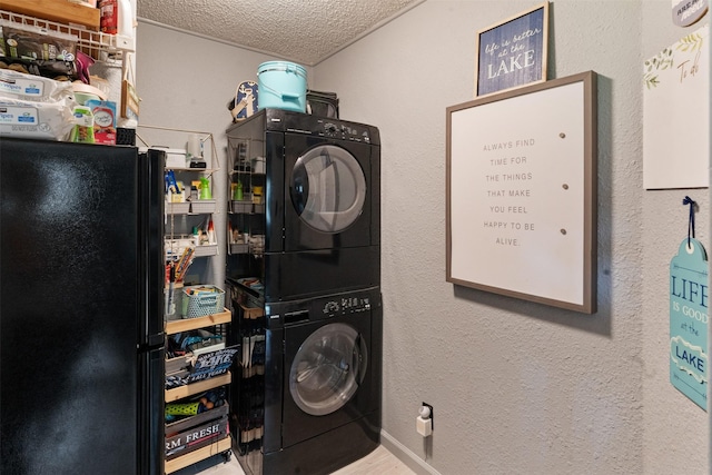 166 Ocean Dr, Gun Barrel City, TX 75156 - laundry area featuring stacked washer / drying machine, a textured ceiling, a textured wall, and wood finished floors