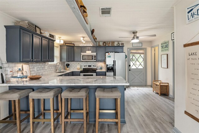 166 Ocean Dr, Gun Barrel City, TX 75156 - kitchen with refrigerator with ice dispenser, electric range, a sink, a peninsula, and backsplash