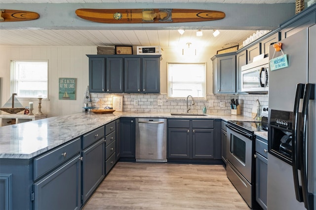 166 Ocean Dr, Gun Barrel City, TX 75156 - kitchen featuring stainless steel appliances, a sink, a peninsula, plenty of natural light, and wooden ceiling with exposed beams