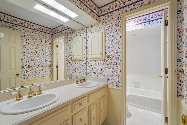 6 Shenandoah Pl, Richardson, TX 75080 - bathroom with wallpapered walls, double vanity, toilet, tile patterned flooring, and a wainscoted wall