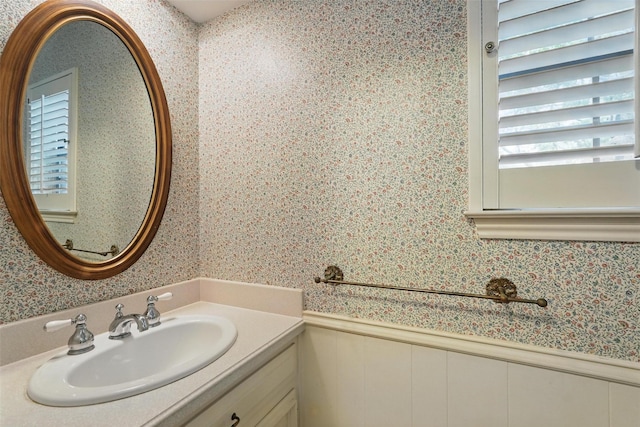 6 Shenandoah Pl, Richardson, TX 75080 - bathroom featuring wallpapered walls, vanity, wainscoting, and a decorative wall