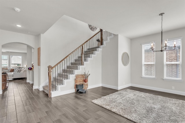 4444 Blue Mist Dr, Fort Worth, TX 76036 - stairway with arched walkways, wood finished floors, a chandelier, baseboards, and recessed lighting