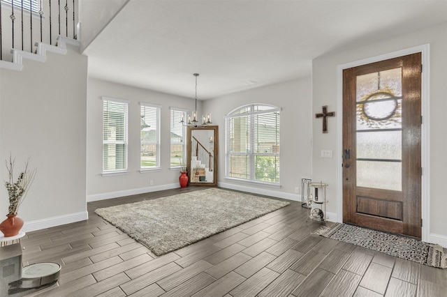 4444 Blue Mist Dr, Fort Worth, TX 76036 - entryway with a chandelier, wood finish floors, baseboards, and stairway