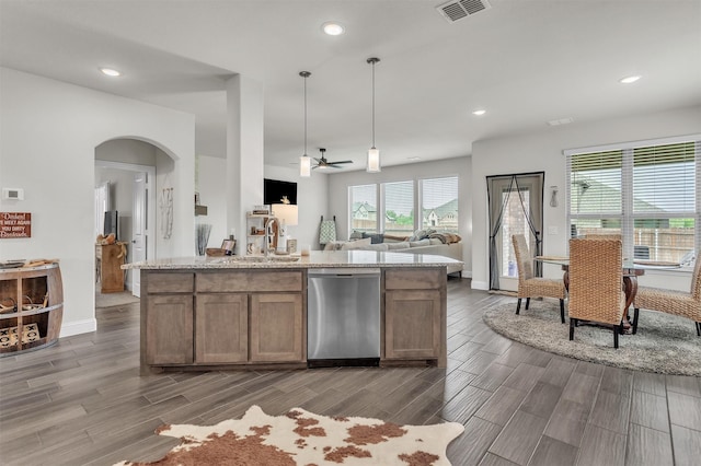 4444 Blue Mist Dr, Fort Worth, TX 76036 - kitchen featuring stainless steel dishwasher, open floor plan, a sink, wood tiled floors, and arched walkways