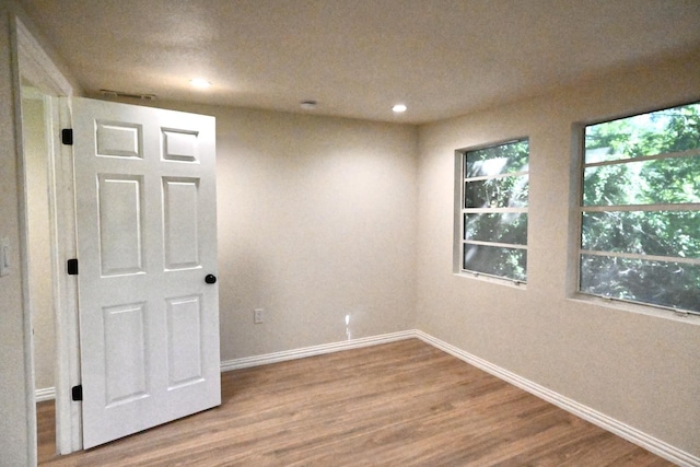 220 Seabreeze Dr, Gun Barrel City, TX 75156 - unfurnished room featuring wood finished floors, plenty of natural light, baseboards, and recessed lighting