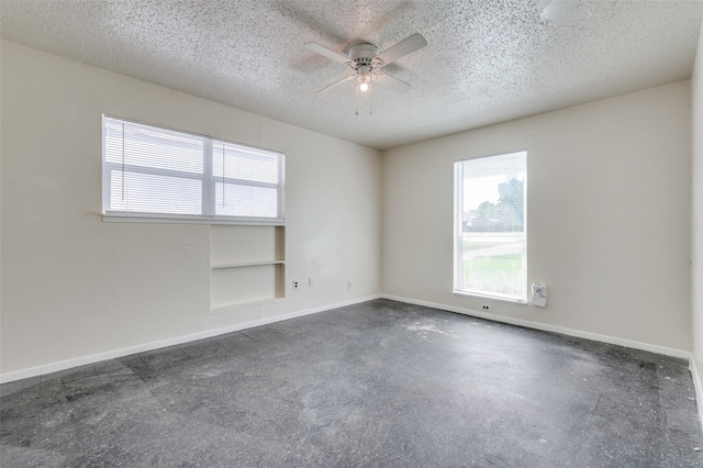 110 Muleta Dr, Oak Point, TX 75068 - empty room with ceiling fan, baseboards, a textured ceiling, and concrete flooring