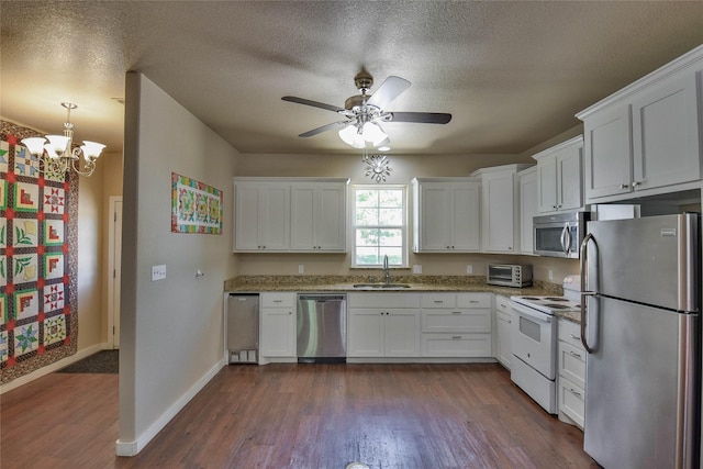 6495 Smoky Hill Ct, Granbury, TX 76049 - kitchen with appliances with stainless steel finishes, a sink, white cabinets, baseboards, and dark wood-style floors