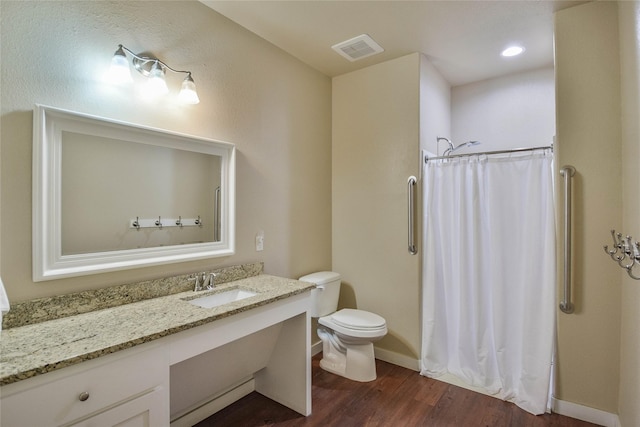 6495 Smoky Hill Ct, Granbury, TX 76049 - bathroom featuring wood finished floors, toilet, baseboards, vanity, and curtained shower