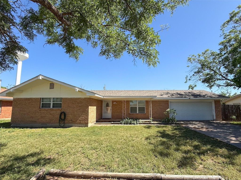 1503 4th St, Roscoe, TX 79545 - single story home with brick siding, an attached garage, concrete driveway, and a front lawn