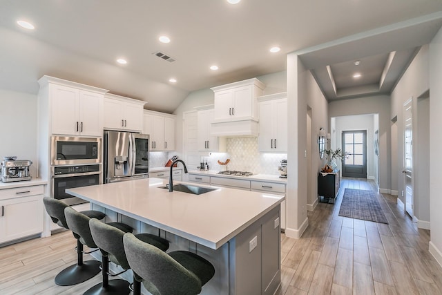 1704 Cypress Gap Trl, Mansfield, TX 76063 - kitchen featuring appliances with stainless steel finishes, a sink, tasteful backsplash, light countertops, and recessed lighting