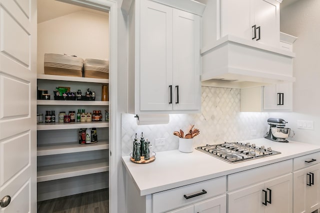 1704 Cypress Gap Trl, Mansfield, TX 76063 - kitchen featuring stainless steel gas cooktop, decorative backsplash, white cabinetry, light countertops, and wood finished floors