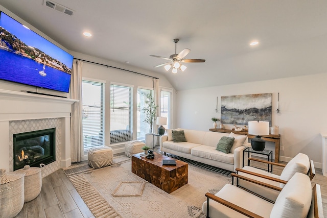 1704 Cypress Gap Trl, Mansfield, TX 76063 - living area featuring wood finished floors, ceiling fan, lofted ceiling, a tiled fireplace, and recessed lighting