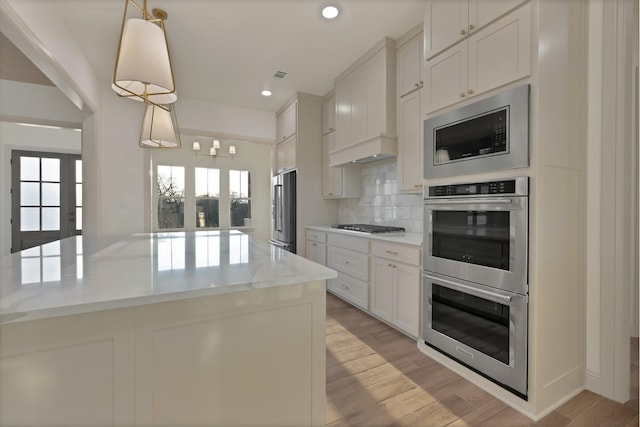 2113 Dicey Rd, Weatherford, TX 76085 - kitchen featuring stainless steel appliances, plenty of natural light, tasteful backsplash, light wood-style floors, and recessed lighting