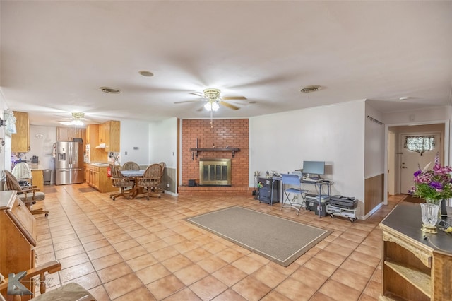 1602 Westwood Dr, Abilene, TX 79603 - living area featuring a ceiling fan, a brick fireplace, and light tile patterned floors