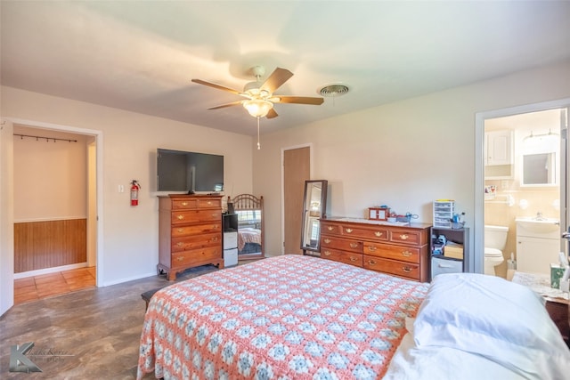 1602 Westwood Dr, Abilene, TX 79603 - bedroom with a sink, baseboards, a ceiling fan, and ensuite bath