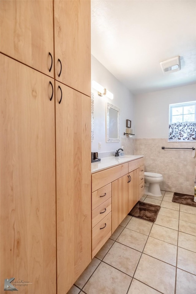 1602 Westwood Dr, Abilene, TX 79603 - bathroom with tile patterned flooring, vanity, tile walls, and toilet