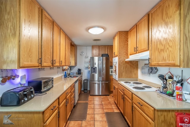 1602 Westwood Dr, Abilene, TX 79603 - kitchen with white appliances, under cabinet range hood, a sink, light countertops, and light tile patterned floors