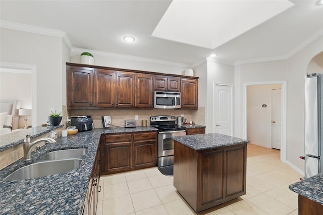 13165 Red Robin Dr, Fort Worth, TX 76244 - kitchen featuring appliances with stainless steel finishes, a sink, crown molding, light tile patterned floors, and backsplash