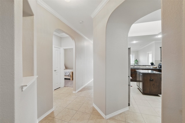 13165 Red Robin Dr, Fort Worth, TX 76244 - hall featuring crown molding, light tile patterned floors, arched walkways, and baseboards