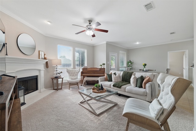 13165 Red Robin Dr, Fort Worth, TX 76244 - living room featuring a ceiling fan, carpet floors, a fireplace with raised hearth, ornamental molding, and baseboards